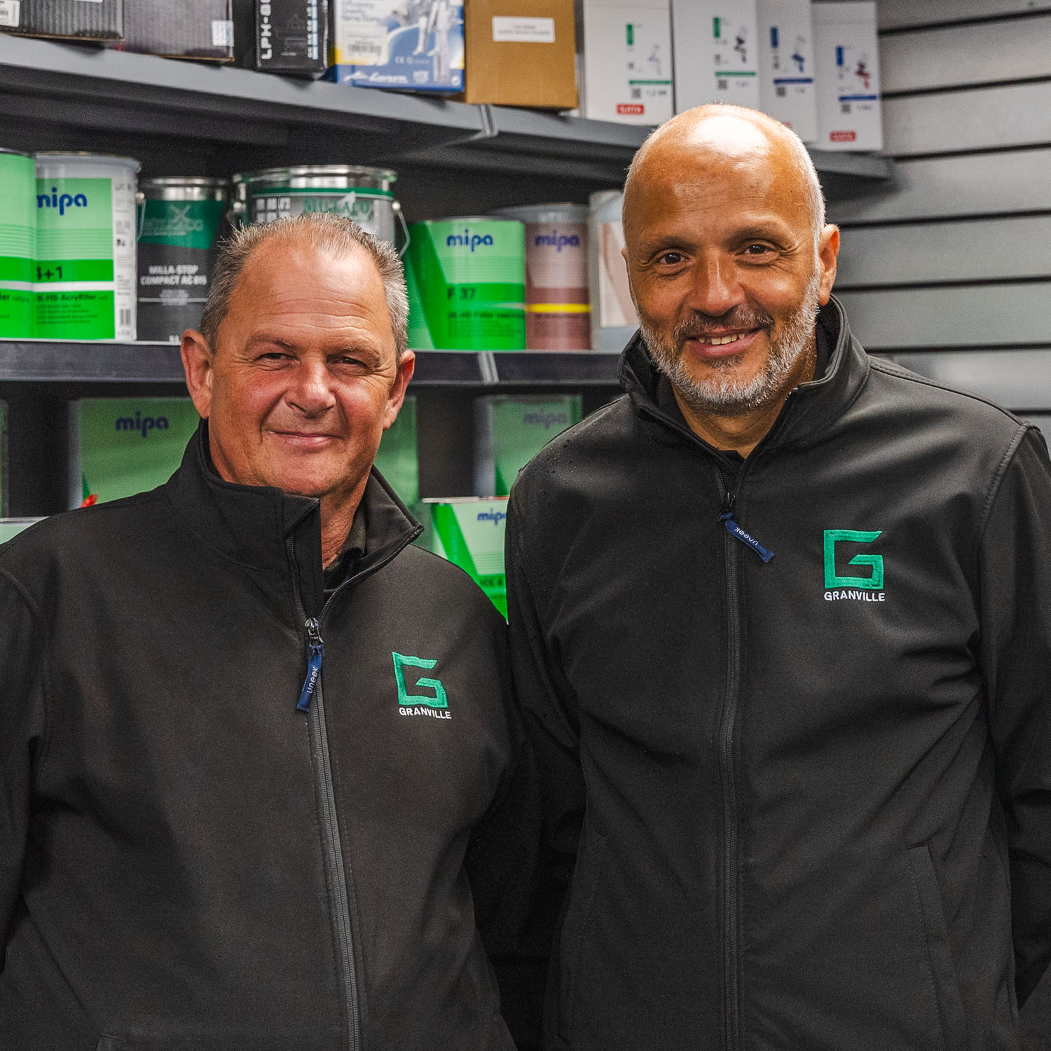 Two Granville Supplies employees smiling at the camera in Granville Supplies business dress.