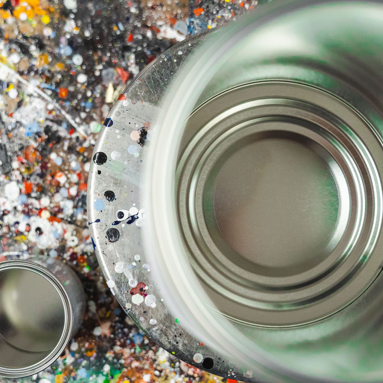 A top-down photograph of an empty paint can on the mixing scales ready to have paint poured into it.